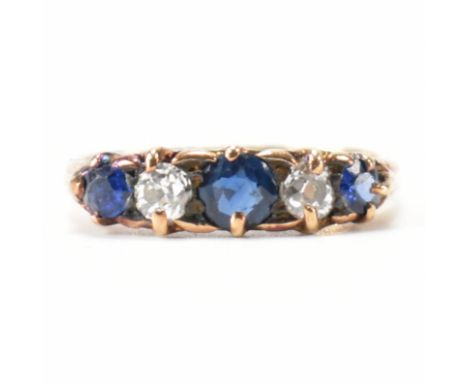 A vintage gold sapphire and diamond ring. The ring being set with three round cut sapphires with two round cut diamonds. Rubb