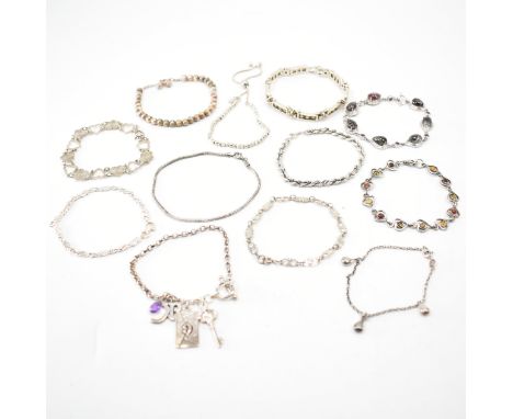 A group of vintage silver bracelets. The lot to include; textured beads, snake chain, rope twist, white stones, brown stones,