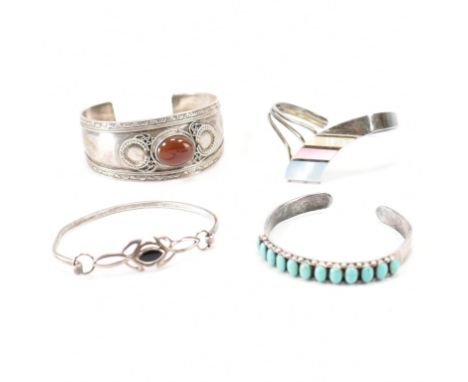 A group of vintage silver bracelet bangles. The lot to include, cuff bangles, mother of pearl, hook &amp; eye bangle, cabocho