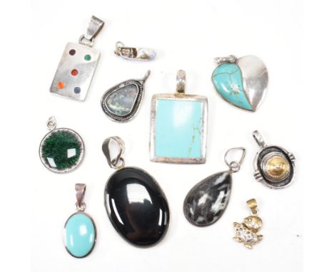 A group of vintage silver necklace pendant charms. The lot to include; gilt gold tone, stone set, faux turquoise, enamel, bla