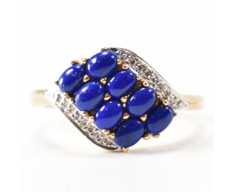 A hallmarked 9ct gold lapis lazuli and diamond crossover ring. Hallmarked Birmingham 2008. Weight 2.9g. Size R.&nbsp;