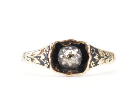 A Victorian gold, diamond &amp; black enamel mourning ring. The ring having a central old cut claw set diamond to a black ena