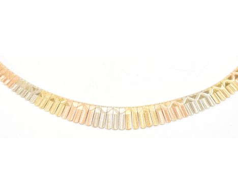 An vintage gold tri tone Cleopatra collar necklace. The necklace having engraved panels with a tongue in groove clasp. Marked