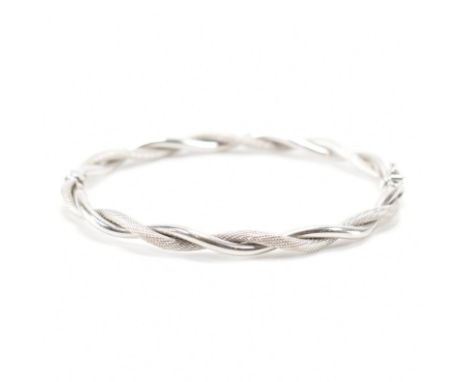 A hallmarked 9ct white gold rope twist bangle bracelet. The bracelet of twist design with hinged opening with a catch clasp. 