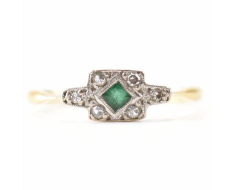 An early 20th Century Art Deco 18ct gold emerald and diamond ring. The ring being set with a central square cut emerald surro