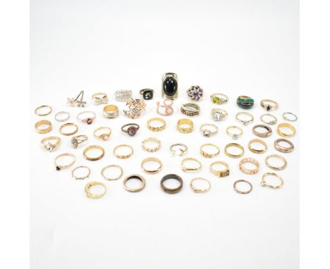 A large collection of yellow metal rings. The lot to include; back enamel, white stones, etched design, prill deign, faux ame