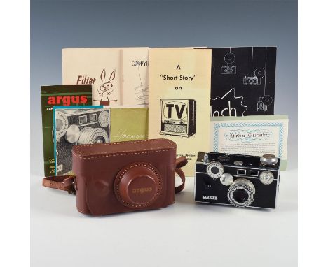 Iconic American camera, leather case, bevy of vintage manuals. Issued: Mid 20th c. Dimensions: 6.25"L x 2.5"D x 4.5"H Manufac