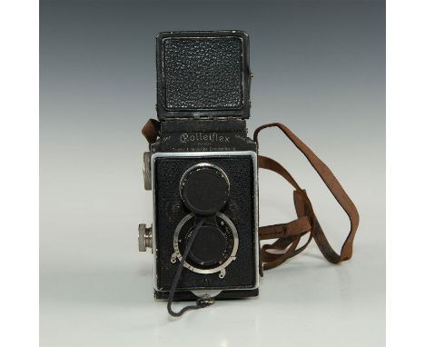 Medium format twin-lens reflex camera with leather strap.Camera in black leatherette covering with chrome controls. It has vi