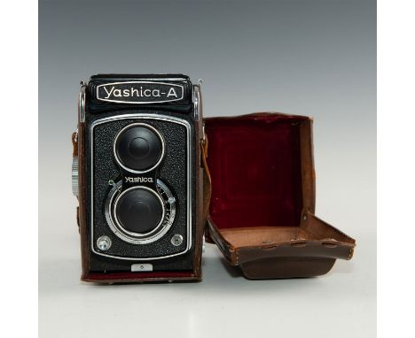 Roll film camera, replete with chrome and leatherette.Medium format 120 roll film TLR camera made byYashica and introduced c.
