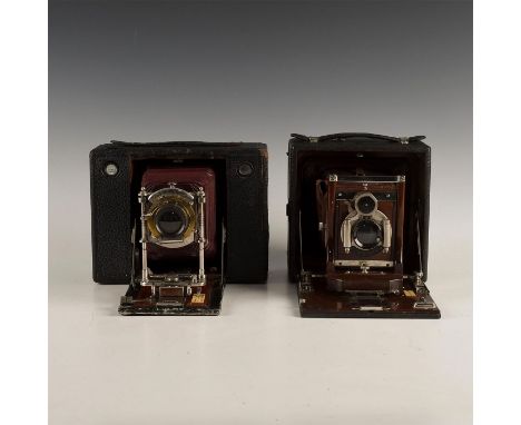 A decorative pair from the Kodak company.Camera made from mahogany wood and cordovan leather. The hardware is made with brass