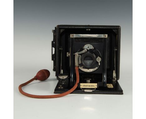 Includes pneumatic shutter release, and one plate holder.Camera is equipped with lens made by Wollensak that is in a Seneca U