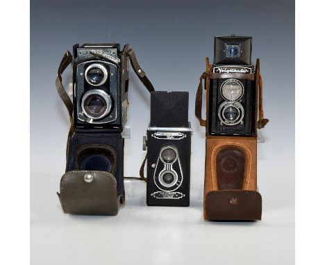 Graflex TLR, Hollywood Reflex TLR, and a Voigtlanderï¿½TLR.Two with leather cases. Medium format roll film cameras includes a
