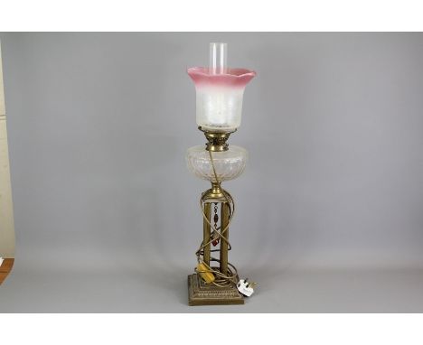 A Victorian Four Pillar Corinthian Oil Lamp; the cut-glass lamp approx 78 cms in h, together with two glass shades and funnel