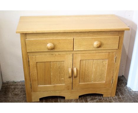 A Bespoke Light Oak Sideboard; the sideboard having two drawers, one shelf and double cupboard doors beneath, approx 102 x 43