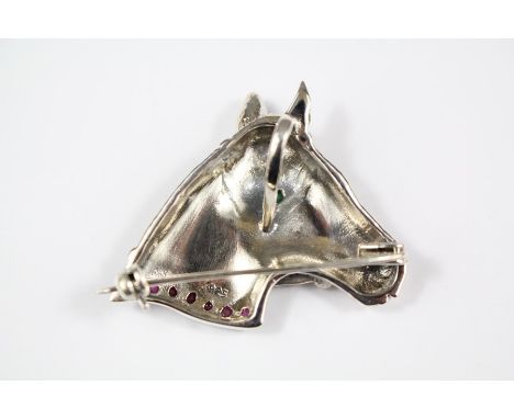 A Silver Horse Brooch, with ruby collar and emerald eye, approx 30 x 30 mm, approx 9.5 gms.