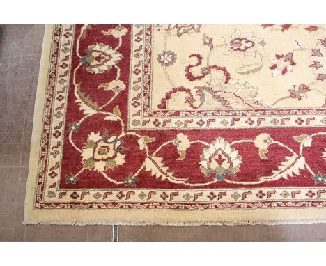 A Large Wool Persian Carpet, the carpet having a cream ground with a foliate terracotta design, approx 250 x 350 cms.