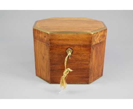 An Antique Mahogany Tea Caddy; the octagonal designed caddy having brass banding, approx 18 X 14 x 14 cms.