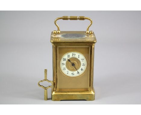 An Antique Brass Carriage Clock; the clock having gilded face with enamel face, numeric dial, Swiss movement, approx 14 x 8 c