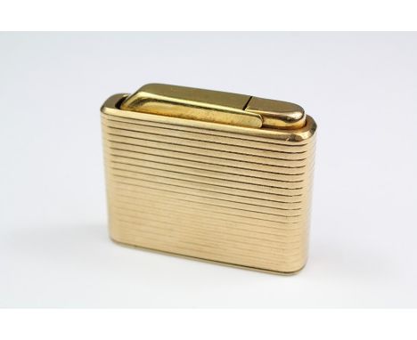 A 9ct Yellow Gold Cased Colibri Lighter, the lighter case with engine turned decoration, 53 x 43 mm, approx 86 gms.