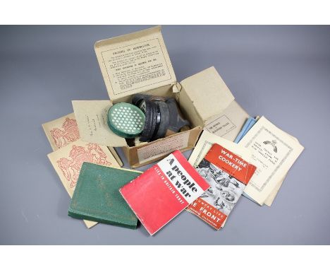 A Boxed WWII Gas Mask, together with a quantity of WWII Instruction Booklets in the event of war, including 'The Defense of B