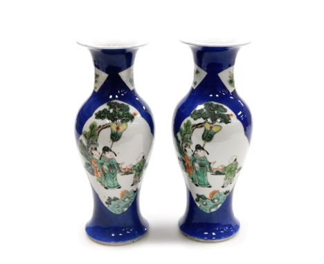 A pair of late 19thC Chinese blue ground porcelain vases, of baluster form, decorated with reserves of figures, blossom, and 