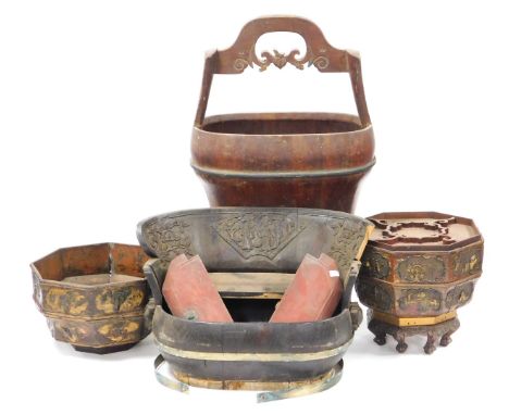 A Chinese oval wooden and brass bound water bucket, with a two part lid and carved swing over handle, 39cm wide, further bras
