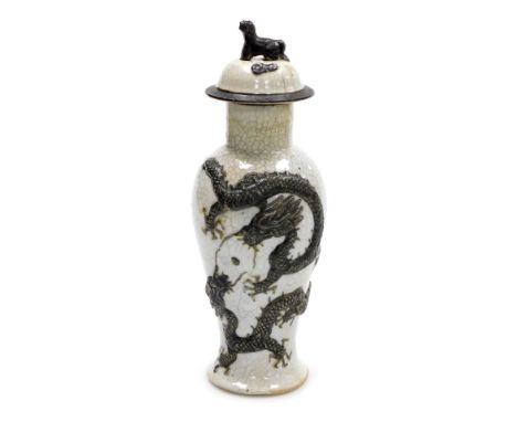 A 19thC Chinese crackle glaze vase and cover, of baluster form, decorated in relief with two Imperial dragons chasing a flami