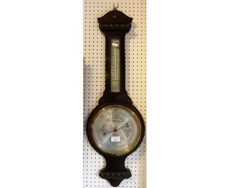 An oak cased aneroid barometer