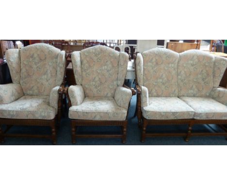 An Ercol ash and elm framed three-piece cottage style suite, with floral loose cushions