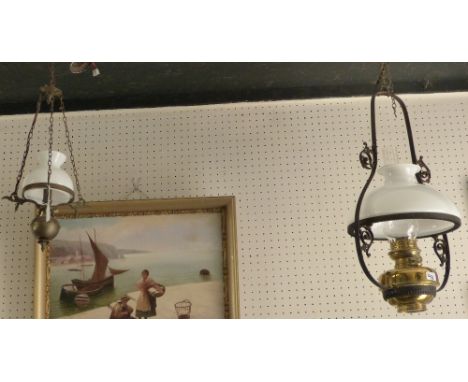 A brass and cast metal hanging oil lamp, together with an electric ceiling light fitting (2)