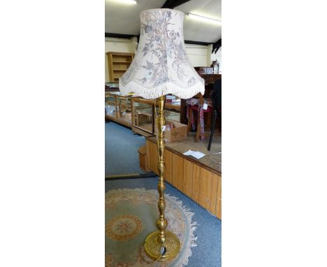 A brass standard lamp and shade