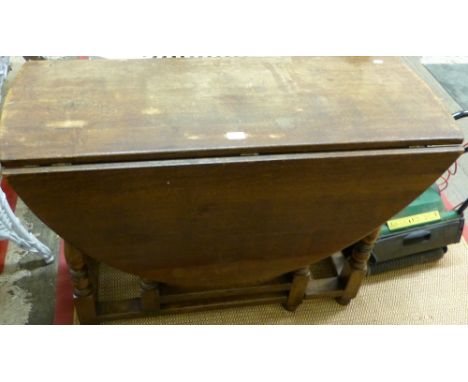 A reproduction 18th century style oak gate-leg dining table, 108cm wide, 134cm extended