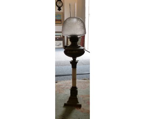 An onyx type brass column table oil lamp, with glass shade and chimney