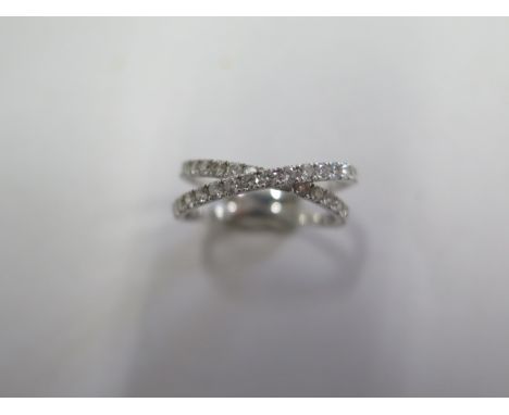 An 18ct white gold diamond crossover ring marked 750 size J/K - approx weight 2.2 grams - in generally good condition, some m