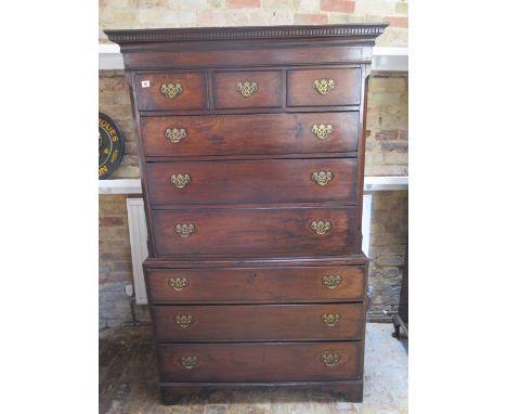 A Georgian oak chest on chest with an arrangement of three small drawers above six long drawers on bracket feet, 181cm tall x
