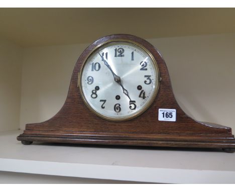 An 8 day oak case mantle clock with Westminster chimes 