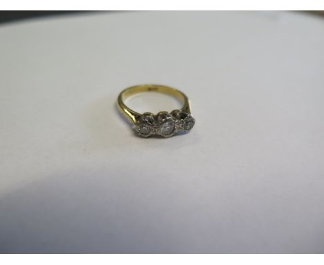 An 18ct yellow gold three stone diamond ring, size M, approx 3.6 grams, diamonds bright with some slight usage wear but gener