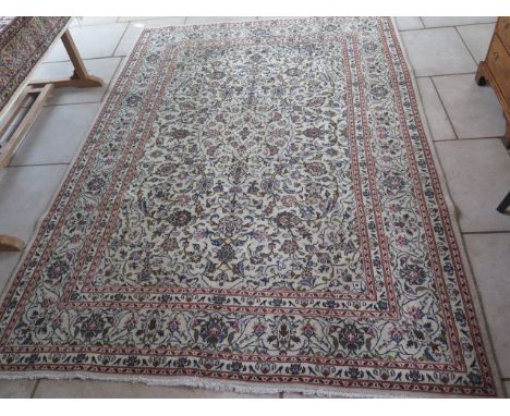 A vintage cream ground Persian Kashan carpet, floral medallion design - 282cm x 200cm some patches of wear but no holes