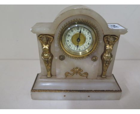 A small alabaster mantle clock by H.A.C, the case decorated with two gilded figures 