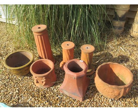 A terracotta plant stand 61cm tall, a pair of smaller stands, two terracotta planters, a small chimney and a dragon planter 2