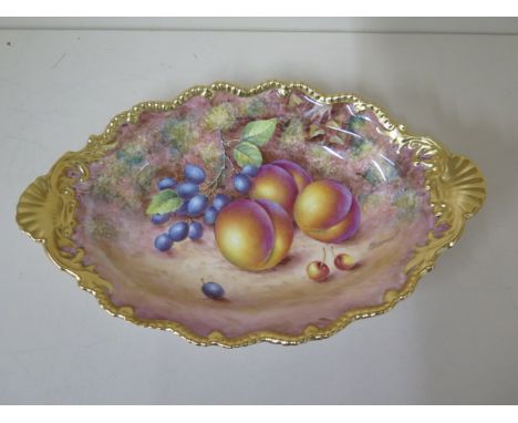 A Royal Worcester oval fine bone china dish with fruit still life on a mossy bank signed Freeman with gilt border and shell h