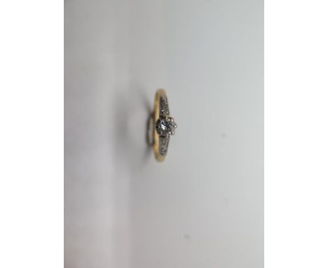 An 18ct gold and platinum diamond ring, size R, approx 2.4 grams, diamond approx 0.20ct, marked 18ct Plat, some wear but gene