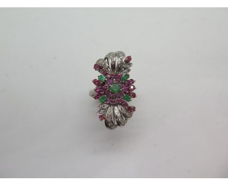 An impressive multi-gem white metal ring set with diamonds, rubies and emeralds, believed to be platinum, head size approx 32