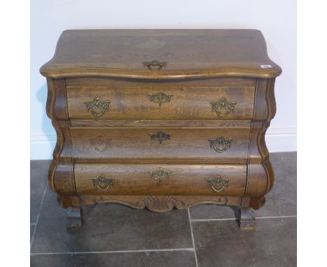 A small oak three drawer bombe shaped chest of drawers - Height 66cm x 76cm x 41cm 