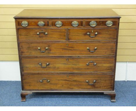 REGENCY MAHOGANY CHEST OF DRAWERS having three slim upper drawers with fancy oval brass plate handles above two short and thr