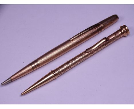 TWO 9CT GOLD STAMPED VINTAGE RETRACTABLE PENCILS, one marked 'Life Long' with banding and engine turn decoration, the other c