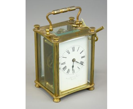 FRENCH BRASS CASED CARRIAGE CLOCK retailed by Finnegans Ltd, Manchester and Liverpool, bevelled edge glass panels with a whit