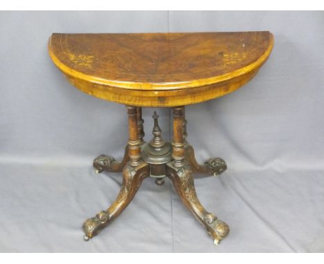 VICTORIAN INLAID WALNUT FOLD-OVER CARD TABLE on an open four column base and carved splayed feet with white pot castors, 74cm