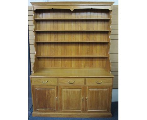 REPRODUCTION LIGHT OAK DRESSER having a four shelf rack with shaped sides on a base of three frieze drawers and three cupboar