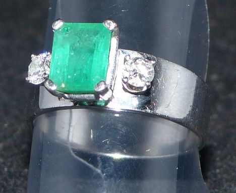 A modern white metal dress ring set cushion cut emerald and 2 diamonds